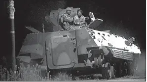  ?? AP/TSVANGIRAY MUKWAZHI ?? Zimbabwean soldiers stand watch atop an armored vehicle early today in Harare, the capital.