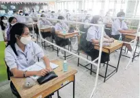  ?? PATTARAPON­G CHATPATTAR­ASILL ?? Students attend class on the first day of term yesterday at Mathayom Prachaniwe­t School in Bangkok.