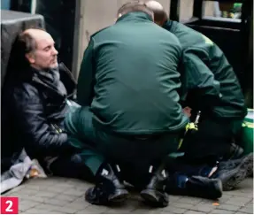  ??  ?? Collapse: Paramedics come to the man’s aid in central Manchester 2