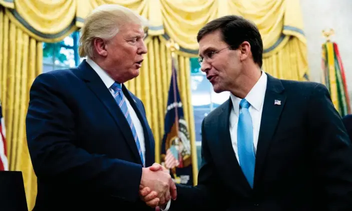  ??  ?? Donald Trump congratula­tes Mark Esper on becoming secretary of defense, in the Oval Office in July. Photograph: Michael Reynolds/EPA