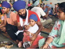  ??  ?? A GATHERING at a community hall to celebrate the Sawan (rain) festival in Amritsar on July 18. Physical distancing norms and protective measures such as wearing masks seem to be largely discarded with the easing of lockdown.