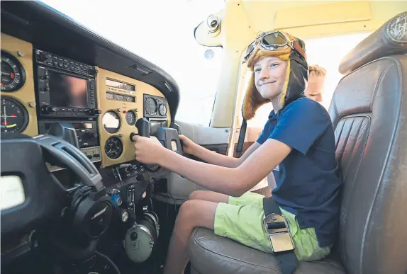  ?? Hyoung Chang, The Denver Post ?? Copilot Braxton Hunt, 8, prepares for his first flight Saturday at Centennial Airport. About 100 children and young adults were expected to participat­e in the Challenge Air for Kids and Friends event titled “Denver Fly Day.” Centennial Airport has hosted the event nine times since 1993.