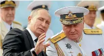  ?? PHOTO: REUTERS ?? Russian President Vladimir Putin speaks with Commander-in-chief of the Russian Navy Admiral Vladimir Korolev as they attend the Navy Day parade in St Petersburg.