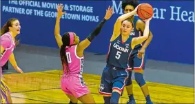  ?? PHOTO COURTESY OF RAFAEL SUANES/GEORGETOWN ATHLETICS ?? UConn’s Paige Bueckers looks to make a pass during the No. 2 Huskies’ 64-40 Big East victory over Georgetown on Friday night in Washington.