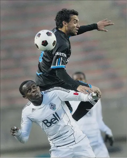  ?? GREG SOUTHAM — EDMONTON JOURNAL ?? FC Edmonton’s Shaun Saiko challenges for a high ball with Vancouver’s Gershon Koffie at Commonweal­th Stadium in Edmonton on Wednesday night.