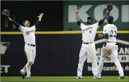  ?? ASSOCIATED PRESS ?? MILWAUKEE BREWERS’ RYAN BRAUN, Christian Yelich and Lorenzo Cain celebrate after winning Game 6 of the National League Championsh­ip Series against the Los Angeles Dodgers Friday.