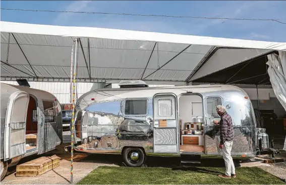  ?? Photos by Sandy Huffaker / For the Washington Post ?? Denny Stone, owner and head of design at So Cal Vintage Trailer, polishes a refurbishe­d Airsteam at his facility in San Diego.