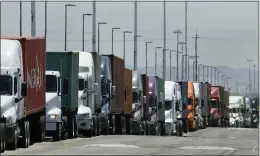  ?? BEN MARGOT — THE ASSOCIATED PRESS ?? Trucks hauling shipping containers wait to unload at the Port of Oakland in Oakland in this 2019photo. The Commerce Department estimate on Thursday of how the U.S. economy performed in the first quarter of 2020was bleak.