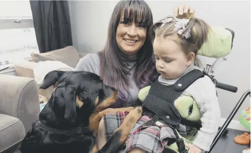  ??  ?? 0 Vicky Cunningham with her daughter Mirryn and their puppy Alvie, who is going to be trained as an assistance dog