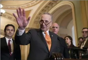  ?? J. SCOTT APPLEWHITE — THE ASSOCIATED PRESS ?? Senate Minority Leader Chuck Schumer, D-N.Y., flanked by Sen. Brian Schatz, D-Hawaii, left, and Sen. Bob Casey, D-Pa., speaks with reporters as work continues on a plan to keep the government open as a funding deadline approaches, at the Capitol in...