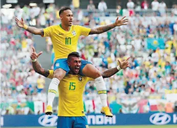  ??  ?? Neymar nos ombros de Paulinho: o Brasil está em alta e prova favoritism­o