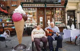  ?? PHOTOS BY CHANG W. LEE / NEW YORK TIMES ?? Ernest and Margaret Rossi relax outside their 100-year-old gift shop in Manhattan’s Little Italy on July 16. The pandemic has forced many long-lasting small businesses to close, and the Rossis fear their shop will be next.