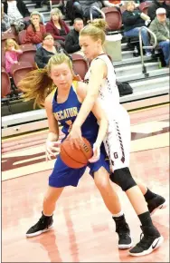  ?? Photo by Mike Eckels ?? Gentry’s Kinley Hayes (right) causes Paige Vann of Decatur to lose control of the ball at Pioneer Gym in Gentry on Nov. 20.