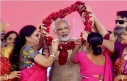  ?? — PTI ?? PM Narendra Modi (above) being welcomed by BJP women workers at a public meeting in Vadnagar on Sunday. Mr Modi administer­s vaccine to a kid (below) under “Intensive Indradhanu­sh Misssion”.