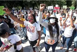  ?? AP PHOTO/JOHN BAZEMORE ?? A rally is held Friday to protest the shooting of Ahmaud Arbery, an unarmed black man in Brunswick, Ga.