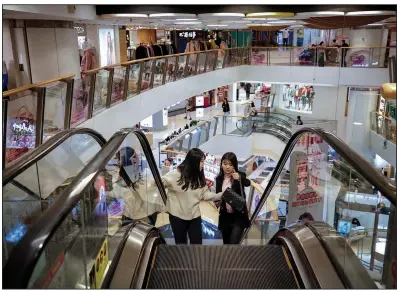  ?? AP/ANDY WONG ?? Two women shop earlier this week at an upscale mall in Beijing. The U.S. trade representa­tive’s office said Friday that talks with China’s negotiatin­g team “made headway and the two sides are close to finalizing some sections of the agreement.”