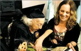  ?? Lake Fong/Post-Gazette ?? Theresia Brandl, 105, a resident of Oakdale, shares a laugh with her great-granddaugh­ter Justine Reyes, 41, after receiving her Sto-Rox High School diploma on Wednesday.