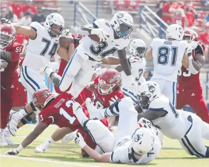  ?? GARY KAZANJIAN/AP ?? Uconn running back Kevin Mensah is stopped after a short gain against Fresno State last Saturday. Mensah, held to just 31 yards on 11 carries, will look to get the Huskies’ running game going today in the home opener against Holy Cross.