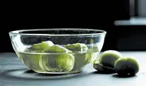  ??  ?? Soaking tomatillos in water makes removing the husks much easier.