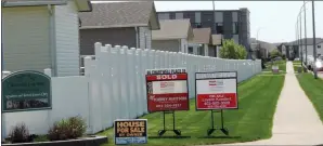  ?? NEWS PHOTO COLLIN GALLANT ?? After a slow winter, the Medicine Hat real estate market is making gains in May, according to the Medicine Hat Real Estate Board. Listing signs appear outside the Chartwell Gardens community in south Medicine Hat on Tuesday.