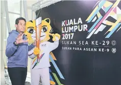  ??  ?? Khairy seen posing with the KL2017 mascot after the press conference.