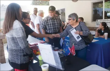  ?? RECORDER PHOTOS BY CHIEKO HARA ?? Maria Roman from Portervill­e College’s Veterans Resource Center (left) greets attendees at the Tule River Native Veterans Stand Down and Resource Fair Wednesday, Oct. 10 at the Tule River Veterans Center. The third annual event offers a variety of resources for veterans of all eras.