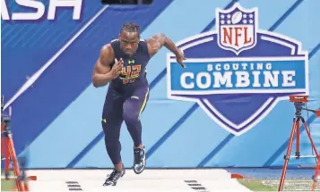  ?? BRIAN SPURLOCK, USA TODAY SPORTS ?? Washington wide receiver John Ross, above, clocked 4.22 seconds in the 40- yard dash Saturday, breaking the scouting combine record of 4.24 seconds set by Chris Johnson in 2008.