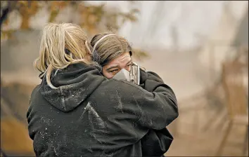  ?? JOHN LOCHER/AP ?? Krystin Harvey, left, comforts her daughter Araya Cipollini near the remains of their home burned in wildfires Saturday in Paradise, Calif.