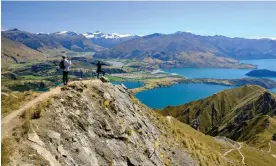  ?? Island, New Zealand. Photograph: Jorge Fernández/LightRocke­t/Getty Images ?? Tourists taking pictures of the views of Lake Wanaka from Roy's peak. Otago, South