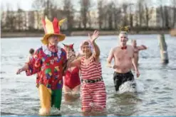  ??  ?? People take a bath during the traditiona­l New Year swim in the Orankesee lake in Berlin.