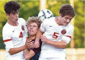  ?? Jerry Baker ?? Cinco Ranch senior midfielder Brady Johnston finds little room to operate in between a pair of Coppell defenders, who helped shut out the Cougars on Friday.