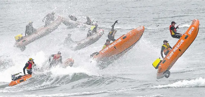  ?? Picture: HARVIE ALLISON ?? Surf lifesavers leap waves during competitio­n at the Australian Inflatable Rescue Boat Championsh­ip at Kingscliff.