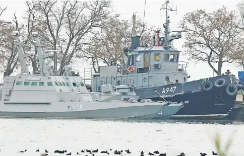  ?? — Reuters photo ?? Seized Ukrainian ships, small armoured artillery ship and a tug boat, are seen anchored in a port of Kerch, Ukraine.