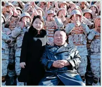  ?? ?? GIRL POWER: Kim and daughter Ju Ae posing with soldiers who were part of the missile test