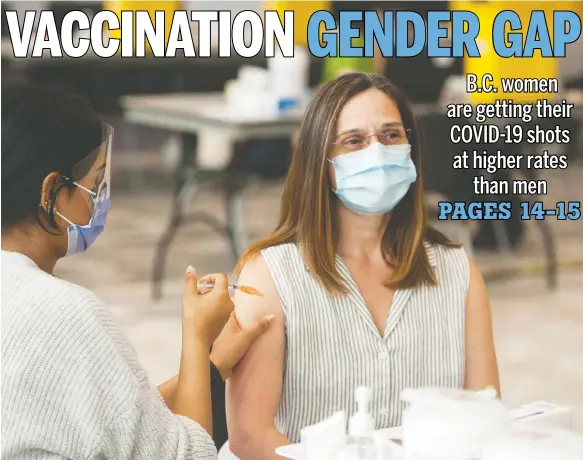  ?? JASON PAYNE ?? Women across Canada, like this woman being jabbed at Vancouver's convention centre last week, are lining up for shots more than men.
