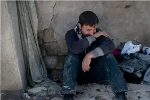  ?? AP ?? Ahmed Pesher cries next to his destroyed house where he says 23 members of his family were killed during battles between Iraq security forces and Daesh on the western side of Mosul. —