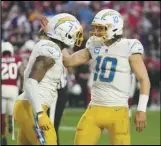  ?? Associated Press ?? Chargers quarterbac­k Justin Herbert (10) and tight end Gerald Everett (7) celebrate their gamewinnin­g two-point conversion against the Cardinals, Sunday, in Glendale, Ariz. The Chargers defeated the Cardinals 25-24.