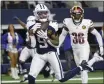  ?? MICHAEL AINSWORTH — AP ?? Dallas Cowboys wide receiver KaVontae Turpin (9) catches a touchdown pass in front of Washington Commanders cornerback Danny Johnson (36) during the second half on Thursday in Arlington, Texas.