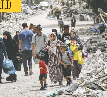  ?? AFP VIA GETTY IMAGES ?? Displaced Palestinia­ns evacuate from the Tal al-Zaatar refugee camp in the northern Gaza Strip on Saturday. Serious doubts have been cast on Hamas claims that 70 per cent of Palestinia­n casualties were women and children.