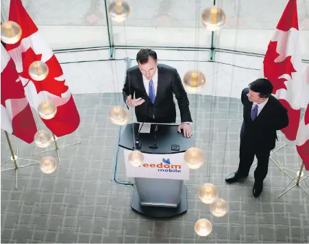  ??  ?? Federal Finance Minister Bill Morneau joins Shaw president of wireless services Paul McAleese during an announceme­nt for Freedom Mobile during a press conference at the Delta Ocean Pointe on Friday.