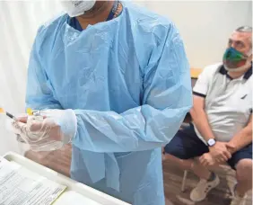  ?? TARIQ ZEHAWI/USA TODAY NETWORK ?? Mike Smith waits to receive a monkeypox vaccine Thursday in Paramus, N.J. Vaccines against the virus have been slow to roll out.