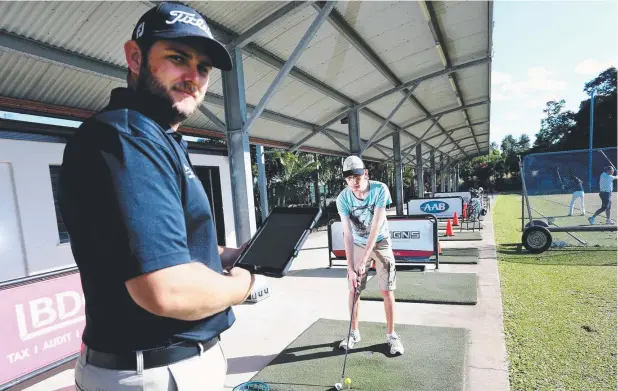  ?? Picture: STEWART McLEAN ?? TOP SHOT: Cairns Golf Club pro Anton Booy coaching deaf man Drew Harper at the driving range ahead of the Disability Action Week Golf Day.