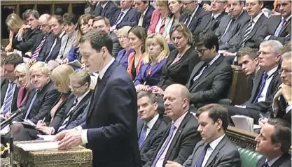  ??  ?? LONDON: A video grab from footage broadcast by the UK Parliament’s Parliament­ary Recording Unit (PRU) shows British Prime Minister David Cameron (R) listening as British Chancellor of the Exchequer George Osborne delivers his Autumn Statement and...