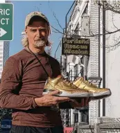  ?? AARON ANKROM / PORTLAND RESCUE MISSION ?? James Free with a pair of gold Nike Air Jordan 3 sneakers at the Portland Rescue Mission on Oct. 30 in Portland, Ore. The rare shoes are up for auction and are expected to raise as much as $20,000.