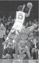  ?? Julie Jacobson / Associated Press ?? Seton Hall guard Myles Powell (13) shoots over Texas Tech guard Justin Gray, who does his best to avoid contact in the second half of Thursday night’s game at New York. Powell led the Pirates with 19 points.