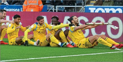  ?? ?? OAR INSPIRING: Andy Carroll finds a novel use for the corner flag as he leads Reading team-mates in celebratio­n after his goal put them 2-1 up