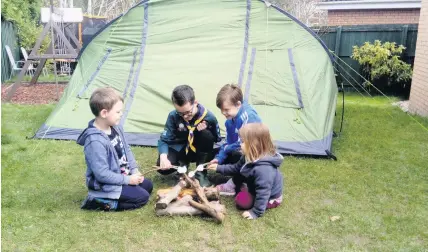 ??  ?? Scout leader Lewis is joined by siblings Struan, Hope and Isla