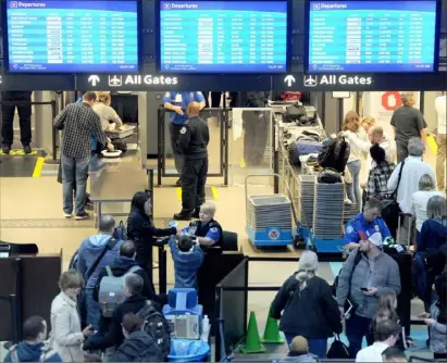  ?? Pam Panchak/ Post- Gazette ?? Transporta­tion Security Administra­tion officers on duty checking passengers through security earlier this year at Pittsburgh Internatio­nal Airport in Moon.