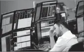  ?? PICTURE: REUTERS ?? A market analyst keeps an eye on the economic trends on the trading floor at IG Index in London.