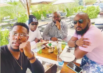  ??  ?? Friends become family… Luis is flanked by his close friends Thomas, Alvaro and Muundu enjoying a meal.